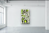 an abstract painting hangs on a wall in an empty room